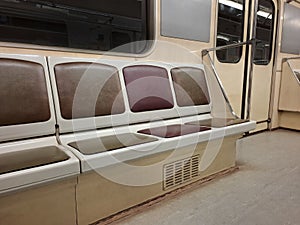 Empty seats without passengers in an empty subway car moving through tunnel