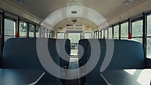 Empty seats placed school bus interior closeup. Safety transport concept.