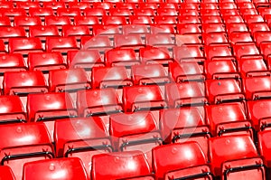 Empty seats red at outdoor stadium.