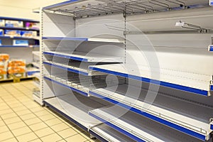 Empty shelves in a store close-up. Concept of deficit in the country. People bought essential products and they are not