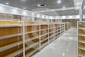 Empty shelves of supermarket interior