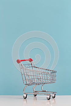 Empty Shopping Cart Against Blue Background