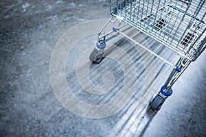 Empty shopping cart on concrete floor