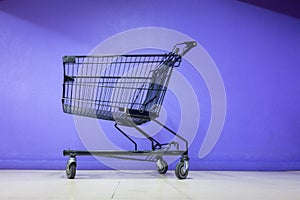 Empty Shopping Cart on Corridor Flooring in Department Store, Trolley Metal for Shopper Consumerism in Supermarket Shop. Shopping