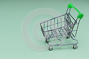 Empty shopping cart on soft blue background, buy and sell concept