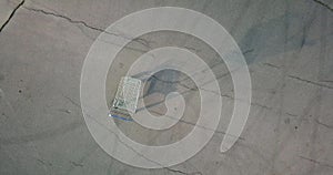 Empty shopping cart standing on chappy asphalt square