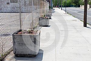 Empty Sidewalk with a Row of Stone Flower Planters in Long Island City Queens New York