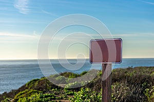 Empty sign frame with copy space, close up, ocean background