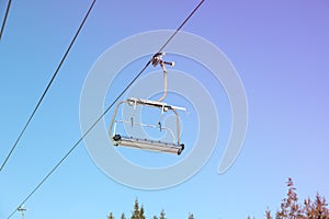 Empty ski lift against blue sky, ski season concept