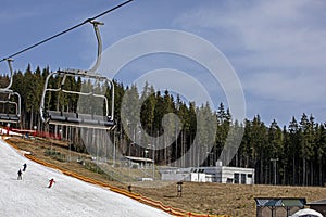 empty ski lift at a ski resort illuminated by the rays of the sun.