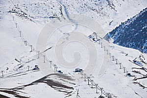 Empty ski resort slope with four chairlifts, view above. Winter sports activities, skiing snowboarding. Recreation place