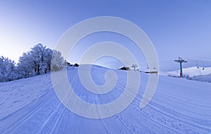 Dawn on an empty ski slope. Panorama.