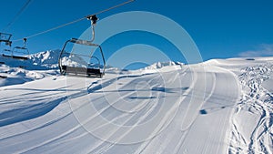 Empty skiing slope and chairlift photo