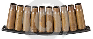 Empty SKS-45 carbine bullet shells in holder over white background