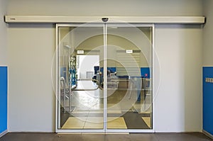 Empty sliding glass front door at the airport. Glass doors in the office. Glass entrance. Entrance to administration photo