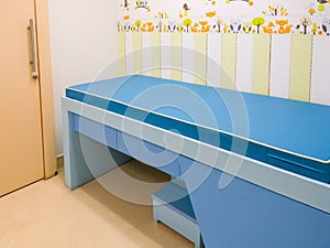 The empty small examination bed in the kid examination room