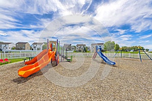 Empty small playground with slides and swings near the houses at Utah Valley