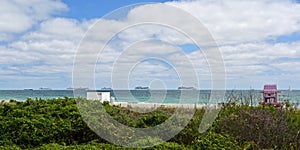 Empty South Beach in Miami Beach, Florida under coronavirus beach closure with cruise ships in background.