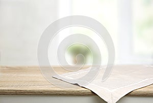 Empty space table decorated with beige towel food advertisement display. Tabletop. Blurred kitchen backdrop. Food promotion