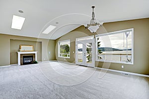 Empty spacious living room with walkout deck and fireplace. photo