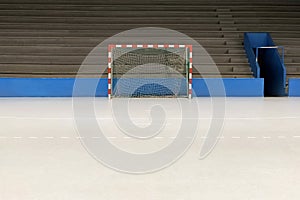 empty sports hall with goals and bleachers