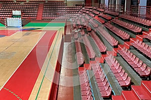 empty sports hall with wooden floor and bleachers