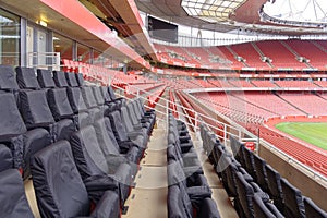 Empty sports stadium with red seats