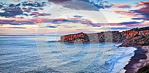 Empty spring view of Torre Conca beach. Dramatic sunset on Rais Gerbi cape. Colorful seascape of Mediterranean seaon the northern