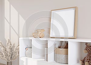 Empty square picture frame standing on sideboard in modern child room. Frame mock up in contemporary style. Free, copy