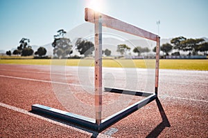 Empty stadium, field and running hurdle or barrier at outdoors race track. Sports, athletics or jumping obstacle, metal