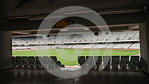 Empty stadium with lush green grass on the playing field