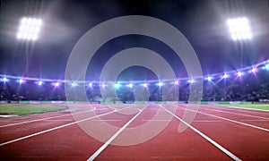 Empty stadium with running track at night