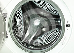 An empty stainless steel bubbled drum of washing machine through opend door