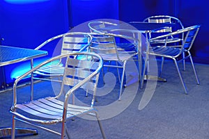 Empty stainless steel chairs and tables