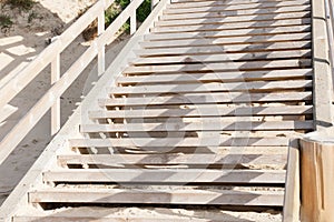 Empty staircase wooden stairs goes to sand sea in lacanau beach ocean