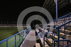 empty stands at the football stadium at night