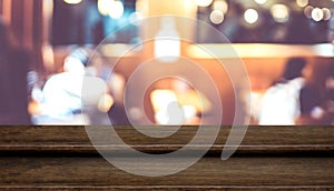 Empty step dark wood table top food stand with blur people dinning in cafe restaurant background bokeh,Mock up for product