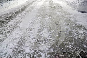 Empty stone causeway and white snow in park at winter night