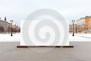 Empty street billboard poster stand with copy space on urban background during bright winter day