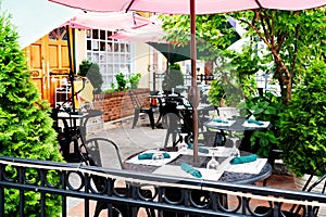 empty street cafe near restaurant in an old American town. Tables and chairs