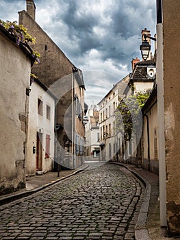 Empty streets of the medieval city of Beaune in Burgundy. The stormy sky