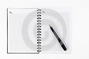 Empty stylish spiral Notepad for notes and a beautiful corporate pen on a white background. Empty space.