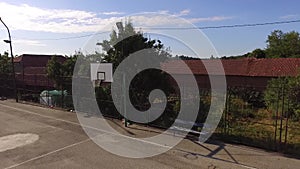 Empty summer basketball court and bench next to