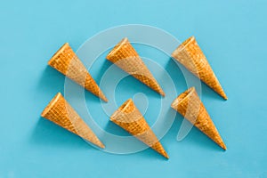 Empty summer ice cream cornets on blue background