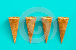 Empty summer ice cream cornets on blue background