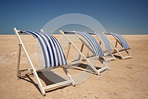 Empty sun chairs in a row
