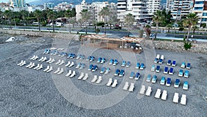 Empty sun loungers on the beach aerial view 4 K Turkey Alanya