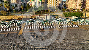 Empty sun loungers on the beach aerial view 4 K Turkey Alanya