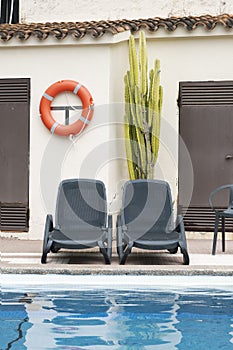Empty sun loungers next to a swimming pool in an empty hotel due to coronavirus pandemics. photo