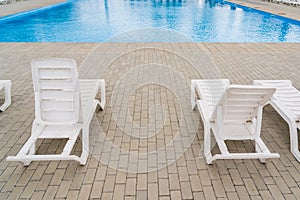 Empty sun loungers in the resort area by the pool. Background with copy space for text